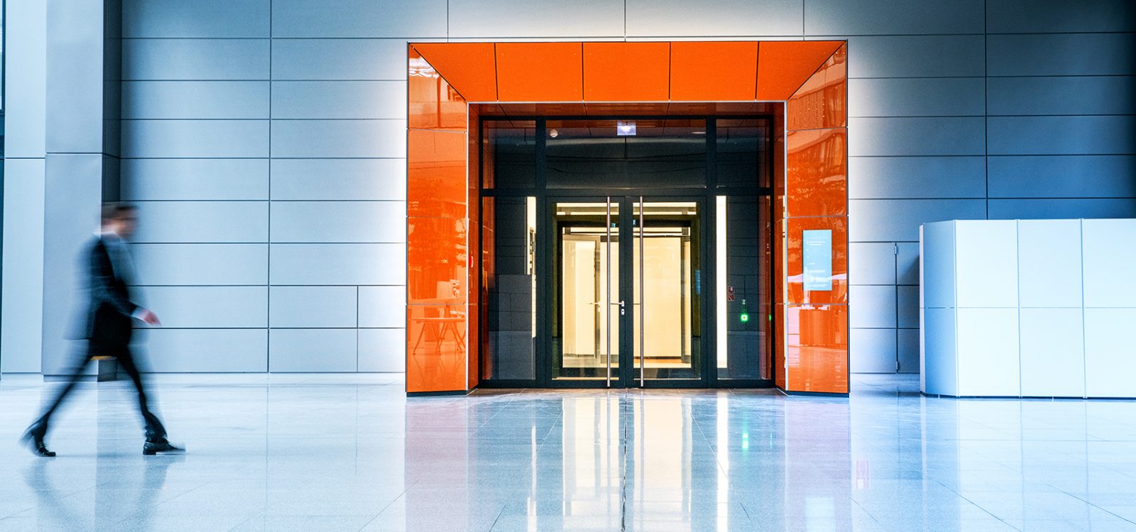 Blurred businessmen walking inside a modern building