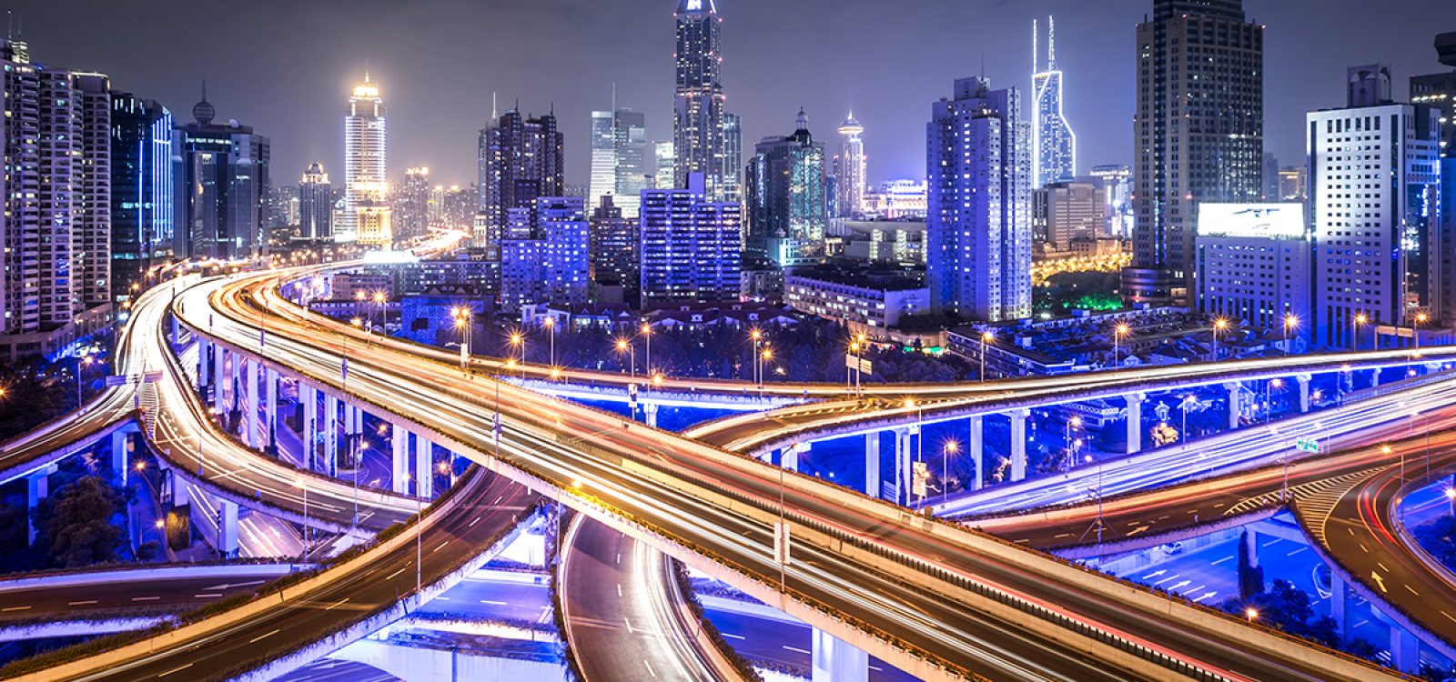 Crowds of cars passing a road intersection in downtown Shanghai.