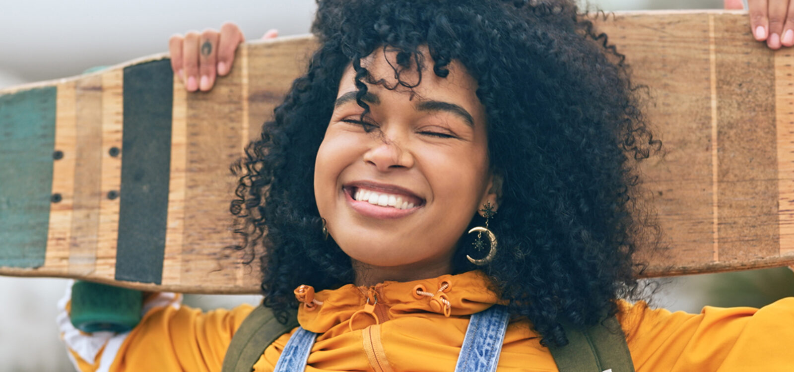 Portrait, black woman with skateboard and smile for training, workout and relax for fun outdoor in street. Skate, young female skater or girl with confidence, ready to practice or freedom for fitness