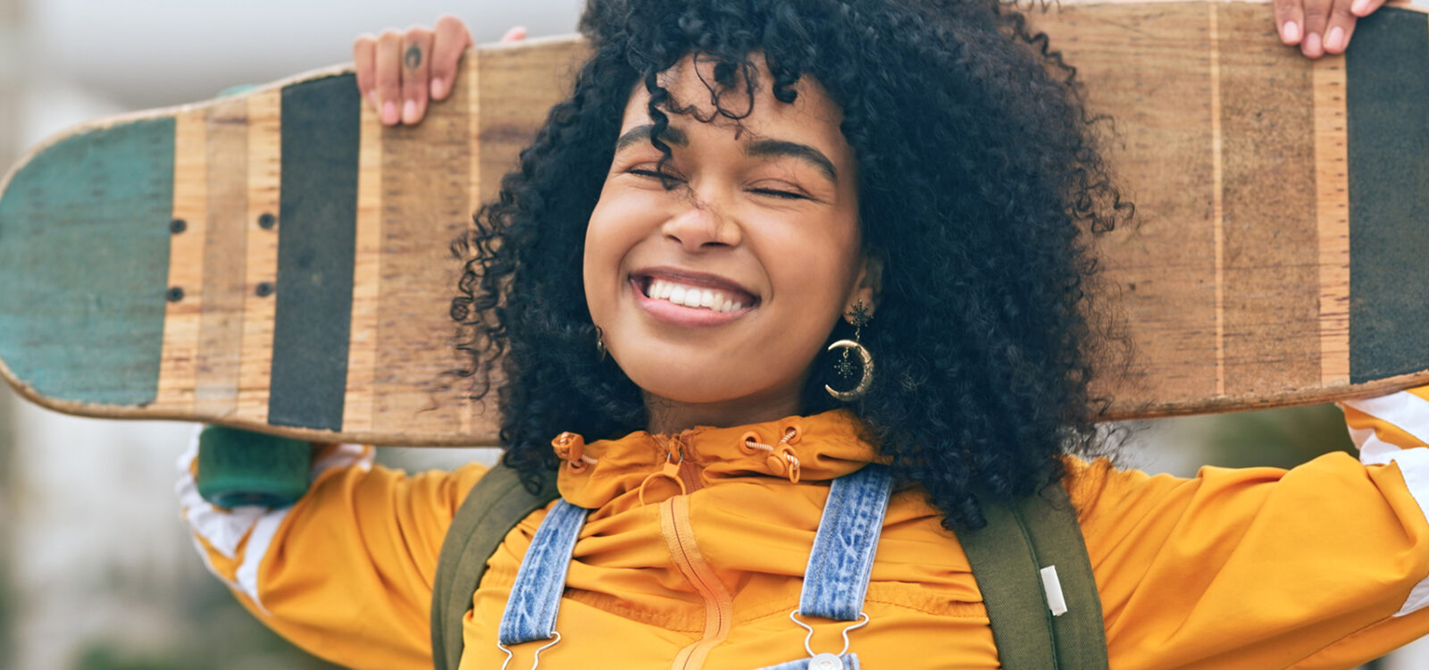 Portrait, black woman with skateboard and smile for training, workout and relax for fun outdoor in street. Skate, young female skater or girl with confidence, ready to practice or freedom for fitness