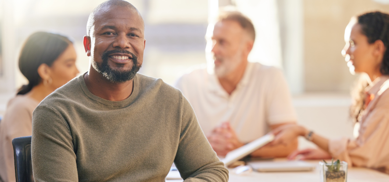 mature businessman at the office sitting in front of his colleagues having a meeting