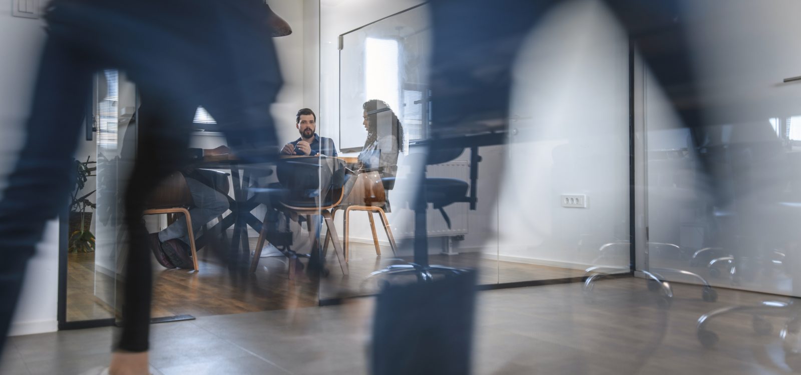 Business Colleagues in Motion Past Office Conference Room