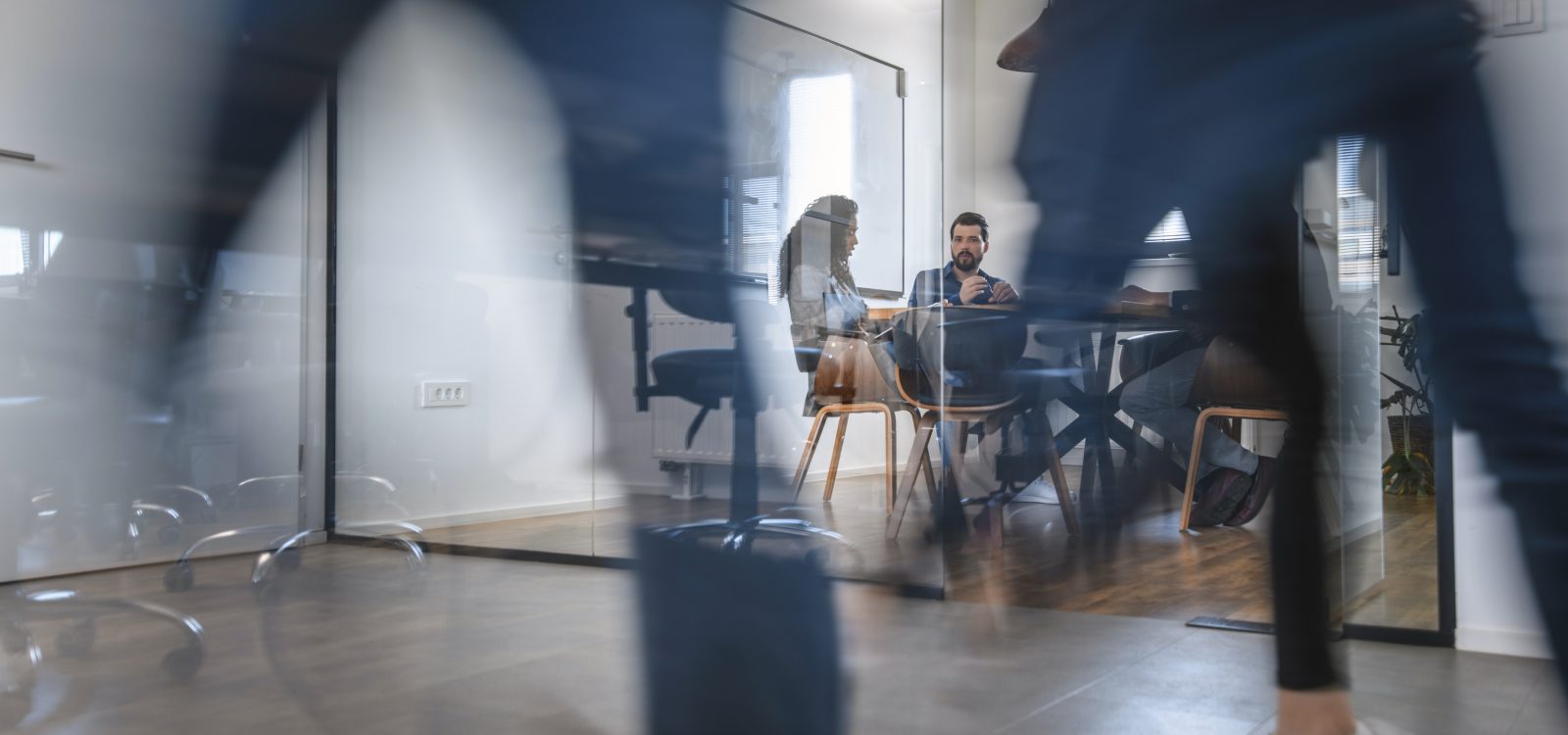 Business Colleagues in Motion Past Office Conference Room
