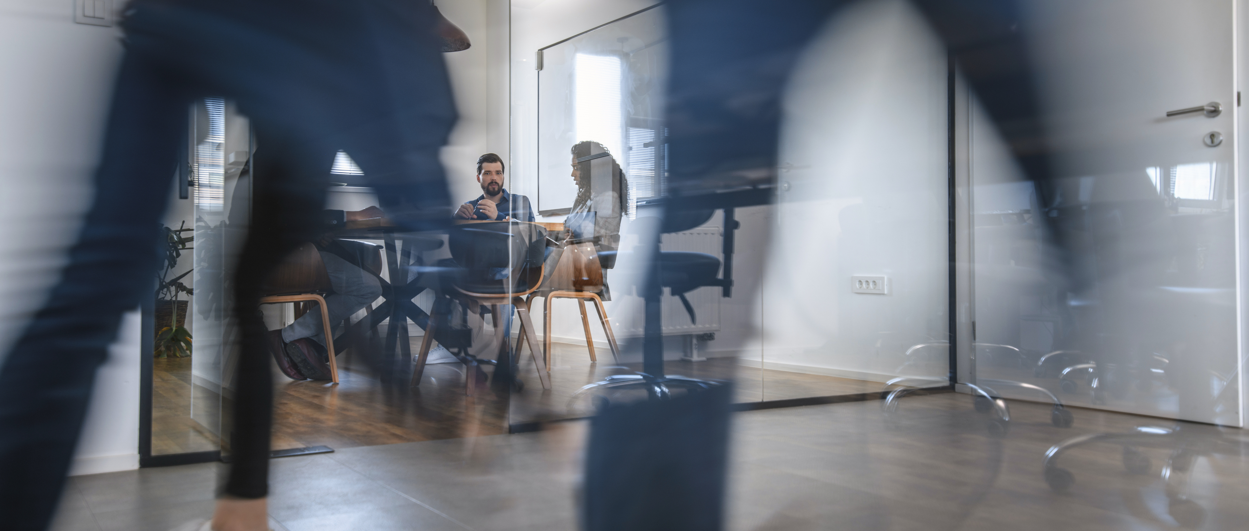 Business Colleagues in Motion Past Office Conference Room
